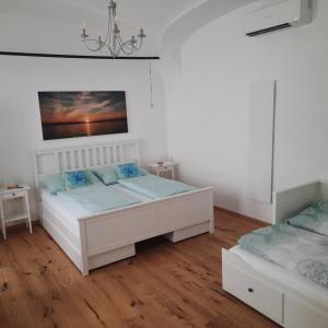 ein Schlafzimmer mit 2 Betten und einem Wandgemälde in der Unterkunft Ferienstube Sonnengruß in Mörbisch am See