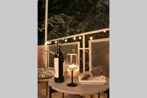 a table with a bottle of wine and a glass at Rox Central Apartments 5 in Timişoara