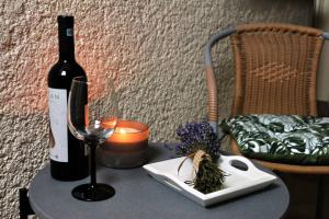 a bottle of wine and a glass on a table at Rox Central Apartments 5 in Timişoara