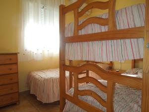 a bedroom with two bunk beds and a bed at Residencial Golf Playa IV in Islantilla +26 photos