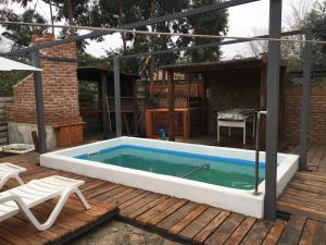 una piscina en una terraza de madera con una mesa en Mi Pesadilla Salinas Home, en Salinas