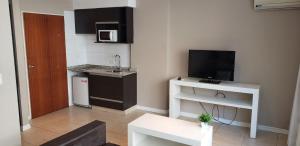 a living room with a small kitchen with a tv at Buenos Aires Loft in Buenos Aires