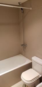 a bathroom with a white toilet and a bath tub at Buenos Aires Loft in Buenos Aires