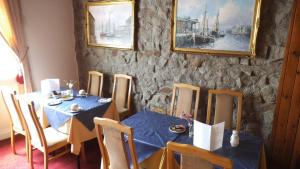 a dining room with a blue table and chairs at Thalatta Guest House in St. Clements