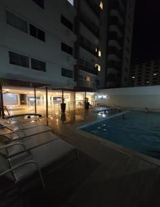 a swimming pool in a building at night at Everest Flat Service - Apartamento 301 in Caldas Novas