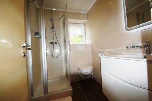 a bathroom with a shower and a toilet and a sink at "Apart Elisabeth" inkl Silvretta Premium Summercard in See +56 photos