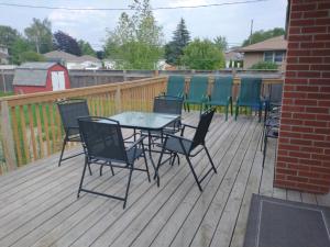 a patio with a table and chairs on a deck at Barrie North Retreat - Quiet and Friendly in Barrie