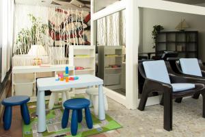 a play room with stools and a table and chairs at Hotel Merano in Grado