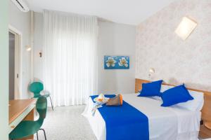 Hotel Gaudia tesisinde bir odada yatak veya yataklar