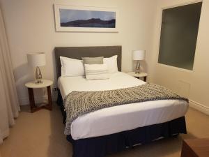 a bedroom with a bed and a lamp at MacArthur Chambers in Brisbane