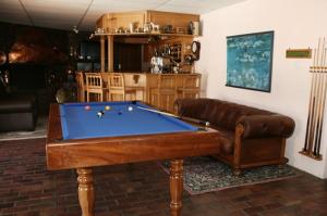 a living room with a pool table and a couch at Majorca House in Somerset West