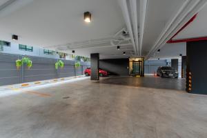 an empty parking garage with cars parked in it at Metro Hotel Ratchada 36 in Bangkok