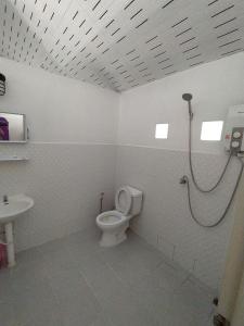 a bathroom with a shower and a toilet and a sink at Kood Life in Ko Kood