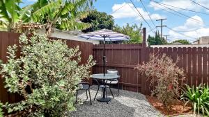 un patio con mesa y sombrilla en Studio Mins to Culver City Downtown, Sony & Venice, en Los Ángeles