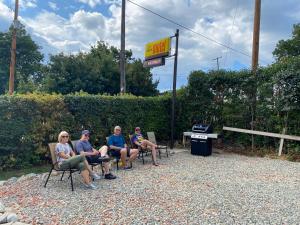 a group of people sitting in chairs at a gas station at City Centre Motel in Creston +4 photos