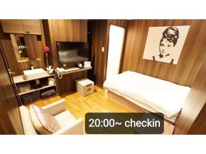 Postel nebo postele na pokoji v ubytování Petit Hotel mio