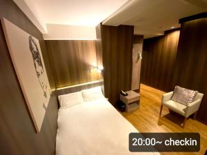 Postel nebo postele na pokoji v ubytování Petit Hotel mio