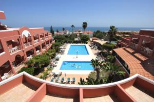 a hotel room with a pool and a balcony at Hotel Belavista Da Luz in Luz