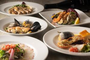a group of plates of food on a table at HOTEL MYSTAYS Yokohama in Yokohama