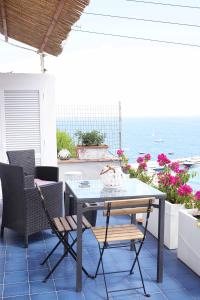 - une table et des chaises sur une terrasse donnant sur l'océan dans l'établissement Casa Tarantino Charming apartments, à Capri