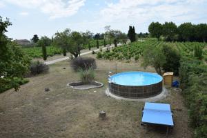 a garden with a hot tub in the middle of a field at Villa de l'Agapé - Drome provencale - 7 ch - 10 à 24 personnes - 350m2 in Tulette
