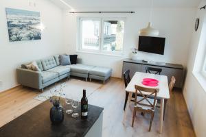 a living room with a couch and a table at Apart Rauchkofel in Lienz