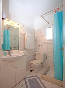a bathroom with a toilet and a sink and a mirror at Joanna Apartments in Mikri Vigla +100 photos