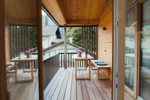 a view of a deck with two tables on a house at Apart Rauchkofel in Lienz