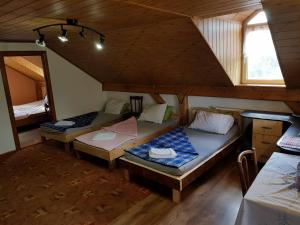 a room with two beds in a attic at Hompot Accommodation in Deva