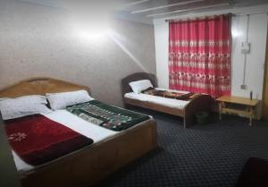 a hotel room with two beds and a window at Green Hill Hotel Thall Kumrat in Tāl