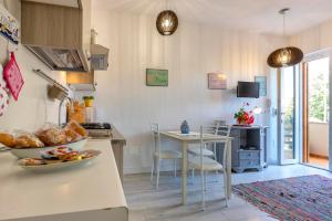 a kitchen with a table and chairs and a dining room at Uva Regina in Alghero