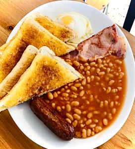 a plate of food with beans and an egg and toast at Top Twenty Bed and Breakfast in Windsor