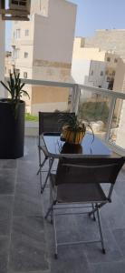 un tavolo in vetro con piante in cima a un balcone di REBAK PLACE- A Bright & charming getaway a Marsaskala
