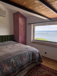 a bedroom with a bed and a large window at Villa The View in Koper