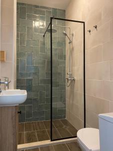 a bathroom with a shower with a glass door at Atelier 26 in Varna City