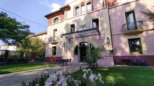 a large white building with flowers in front of it at Villa Regina Margherita in Rovigo