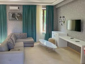 a living room with a couch and a table at Gabala Shooting Club in Gabala