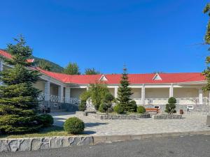 a building with a red roof and a courtyard at Gabala Shooting Club in Gabala +43 photos
