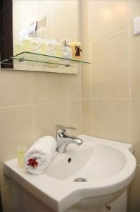 a white bathroom sink with a towel on it at Lux apartment A38, Kraljevi čardaci, Kopaonik in Kopaonik