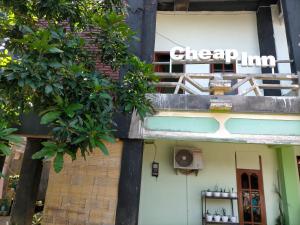 a building with a sign on the side of it at Cheap Inn Banyuwangi in Banyuwangi