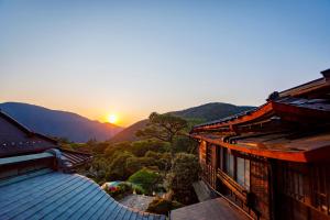 a view of the sunset from the roof of a building at Hakone Kowakien Mikawaya Ryokan in Hakone