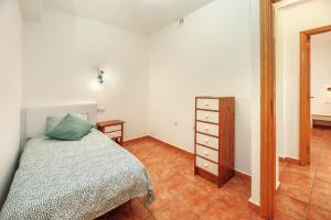 a bedroom with a bed and a dresser in it at Lanzahost Cucharas Dreams in Costa Teguise