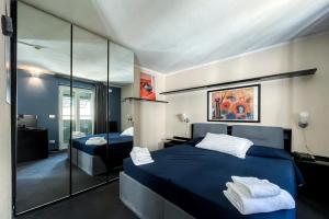 a bedroom with two beds and a large mirror at Hotel Britannia in Genova