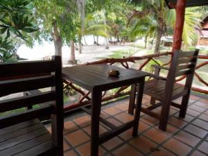 a table and two chairs sitting on a porch at Sea Scene Resort in Wok Tum