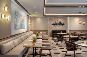 a restaurant with tables and chairs and a fireplace at Radisson Collection Hotel, Bodrum in Akyarlar