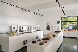 a white kitchen with a counter with pastries on it at Olympios Zeus in Plaka Litochorou