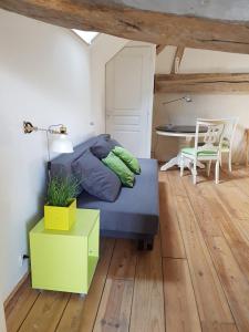 a bedroom with a bed and a table and a desk at Les 7 tilleuls - Gîte in Mesland