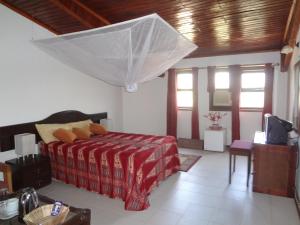 a bedroom with a bed and a television in it at Roc Heights in Bakau +37 photos