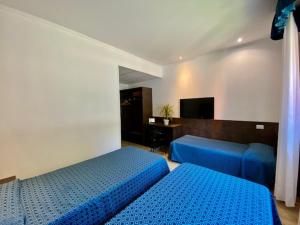 Postel nebo postele na pokoji v ubytování Hotel Garibaldi