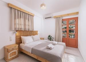 a bedroom with a bed with two towels on it at Amalia in Matala